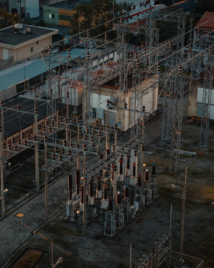 A detailed aerial view of a bustling electrical substation, showcasing industrial infrastructure.
